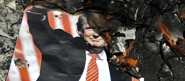 A poster of the U.S. President Donald Trump is set on fire during the annual anti-Israeli Al-Quds, Jerusalem, Day rally in Tehran, Iran, Friday, June 8, 2018 - 俄羅斯衛星通訊社