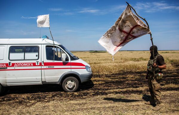 一名烏克蘭軍人打著白旗在中立區轉交死者屍體。 - 俄羅斯衛星通訊社
