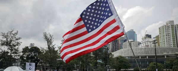A US flag flutters as people gather at Victoria Park to take part in an anti-extradition bill protest in Hong Kong, 11 August 2019.  - 俄羅斯衛星通訊社