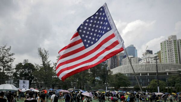 A US flag flutters as people gather at Victoria Park to take part in an anti-extradition bill protest in Hong Kong, 11 August 2019. - 俄罗斯卫星通讯社