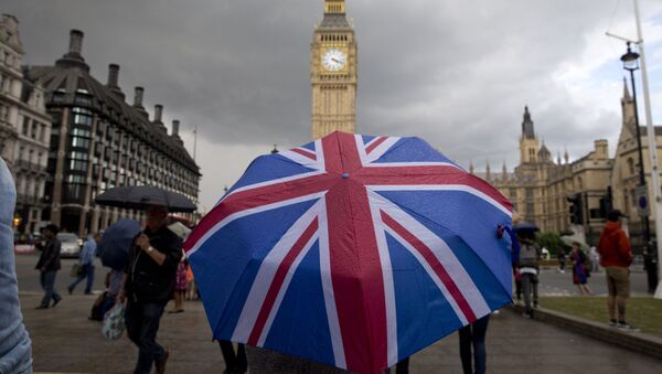 Пешеход с зонтом в цветах британского флага в Лондоне - 俄罗斯卫星通讯社