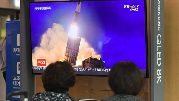People watch a television news screen showing file footage of a North Korean missile launch, at a railway station in Seoul on October 2, 2019. - 俄羅斯衛星通訊社