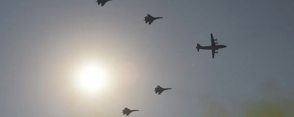 A formation of military airplanes, one Y-8 transport aircraft leading four J-11 air superiority fighters, fly over Beijing during a military parade at Tiananmen Square on October 1, 2019, to mark the 70th anniversary of the founding of the People's Republic of China - 俄罗斯卫星通讯社