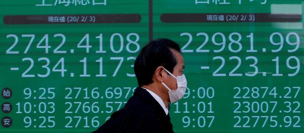 A man wearing a surgical mask walks past a screen showing Shanghai Composite index and Nikkei index outside a brokerage in Tokyo - 俄罗斯卫星通讯社