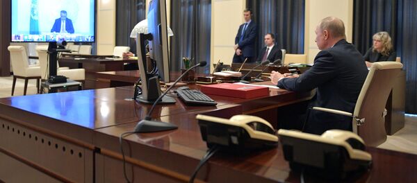 26 марта 2020. Президент РФ Владимир Путин во время участия в саммите лидеров Большой двадцатки по коронавирусу в режиме видеоконференции - 俄罗斯卫星通讯社