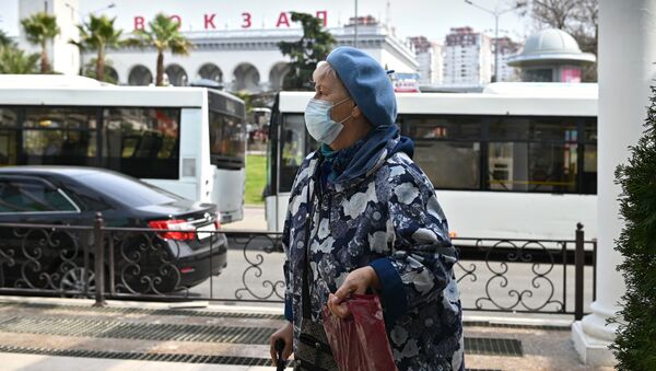 Женщина в медицинской маске на улице города Сочи. - 俄羅斯衛星通訊社