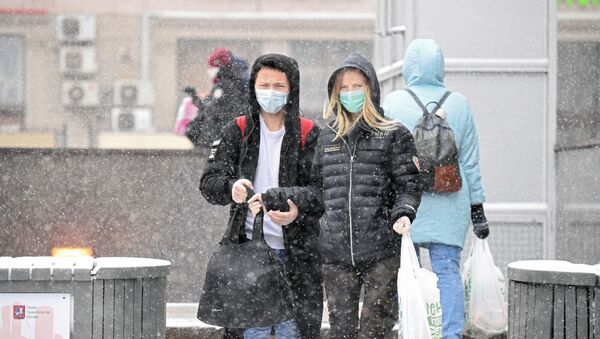 Молодые люди в медицинских масках на одной из улиц в Москве - 俄罗斯卫星通讯社