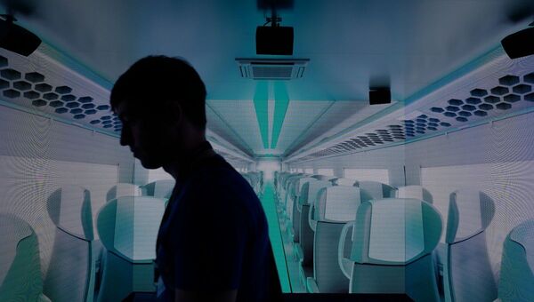 A visitor looks at a projection of a Velaro Novo high speed train made by German industrial giant Siemens at Innotrans, the railway industry’s largest trade fair, in Berlin on September 19, 2018 - 俄罗斯卫星通讯社