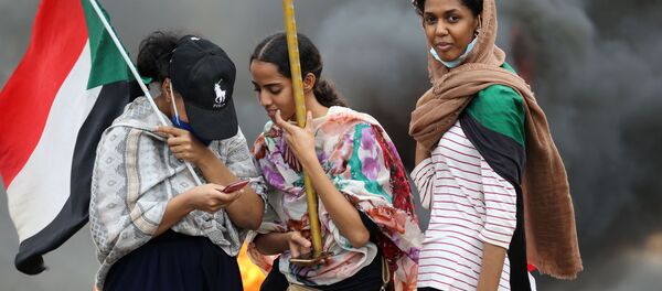 Женщины с флагом во время акции в Хартуме, Судан - 俄罗斯卫星通讯社
